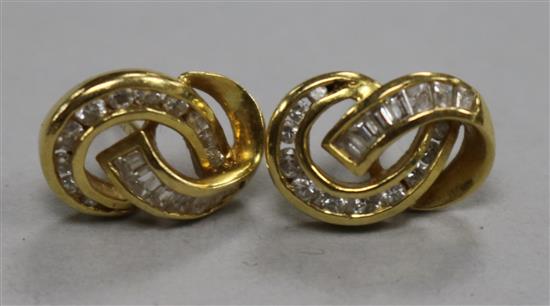 A pair of 18ct gold and diamond scrolling entwined earstuds.